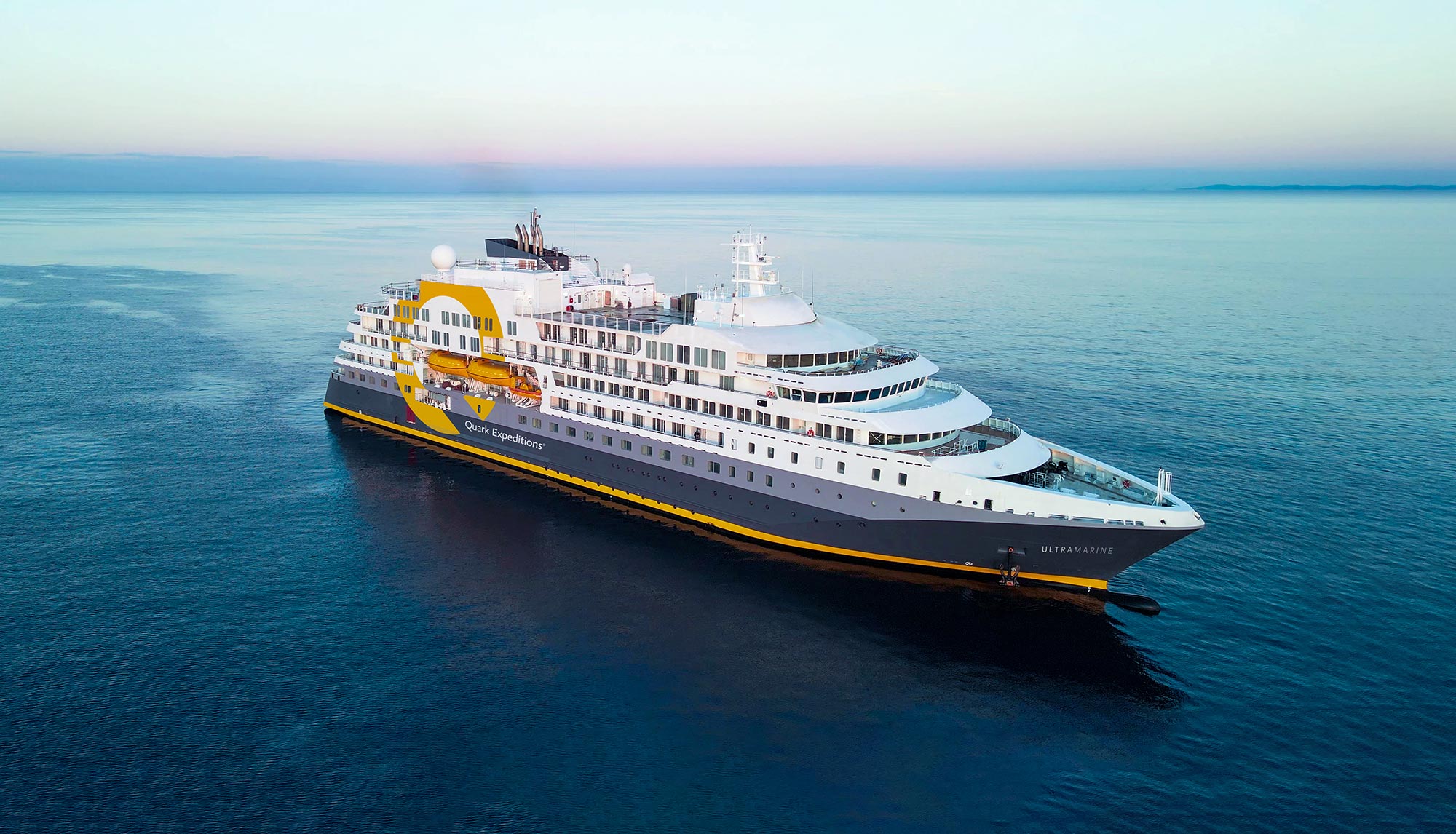 A bird's eye view of the ship Ultramarine sailing on the open ocean.