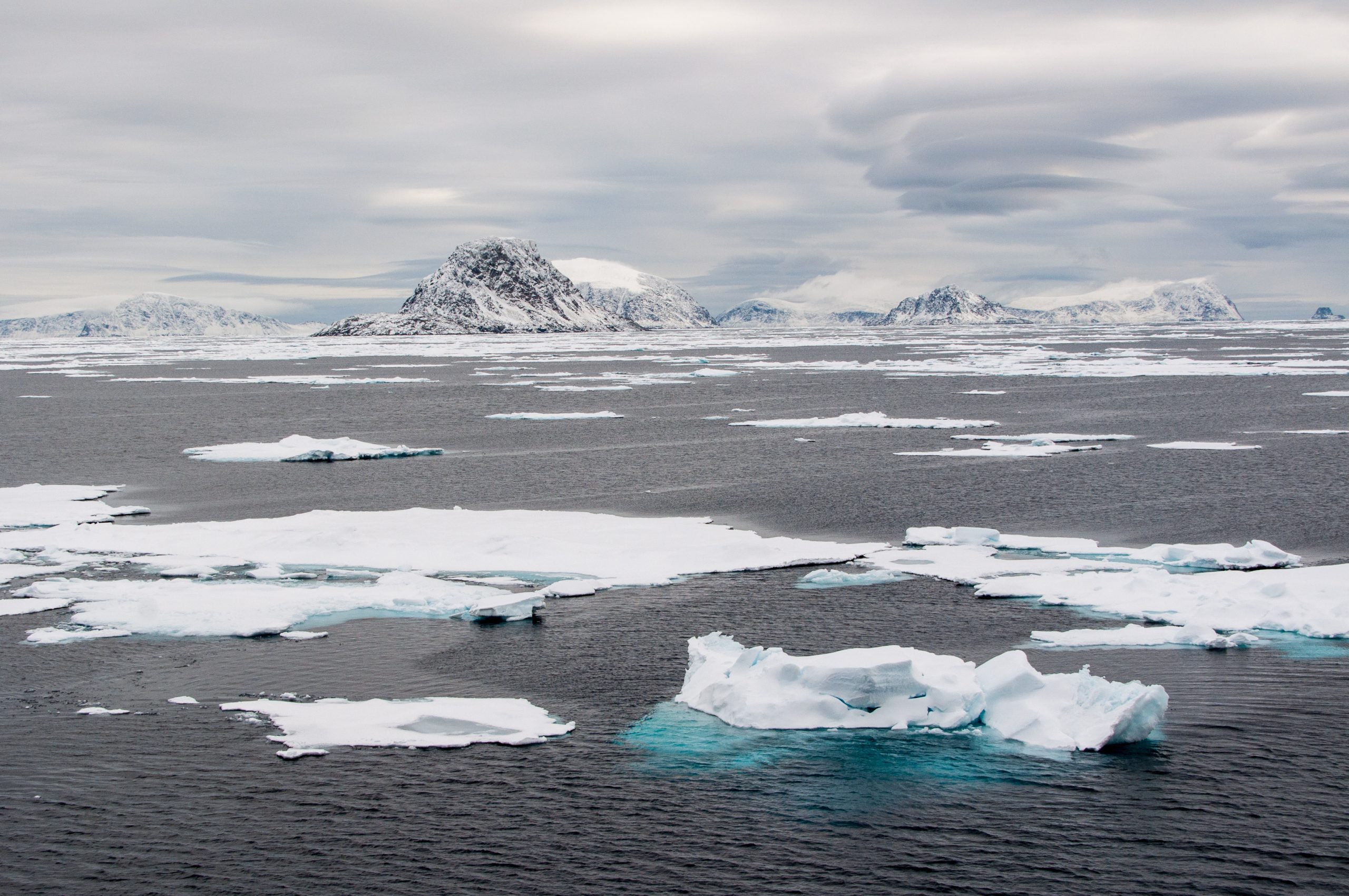 Sea ice with mountains in the distance.