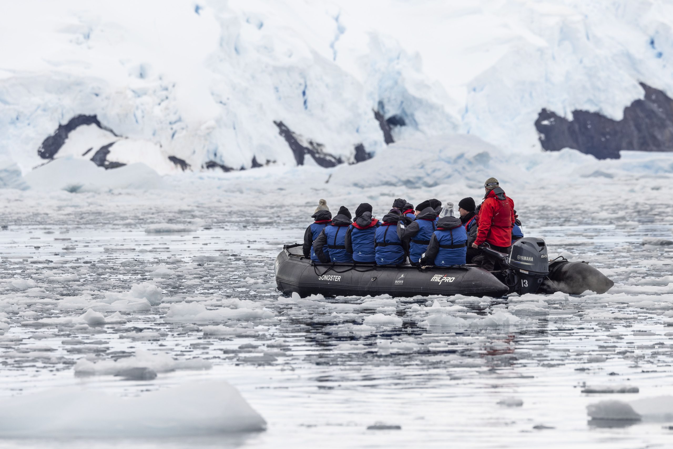 Guests on a zodiac in icy waters in Antarctica.