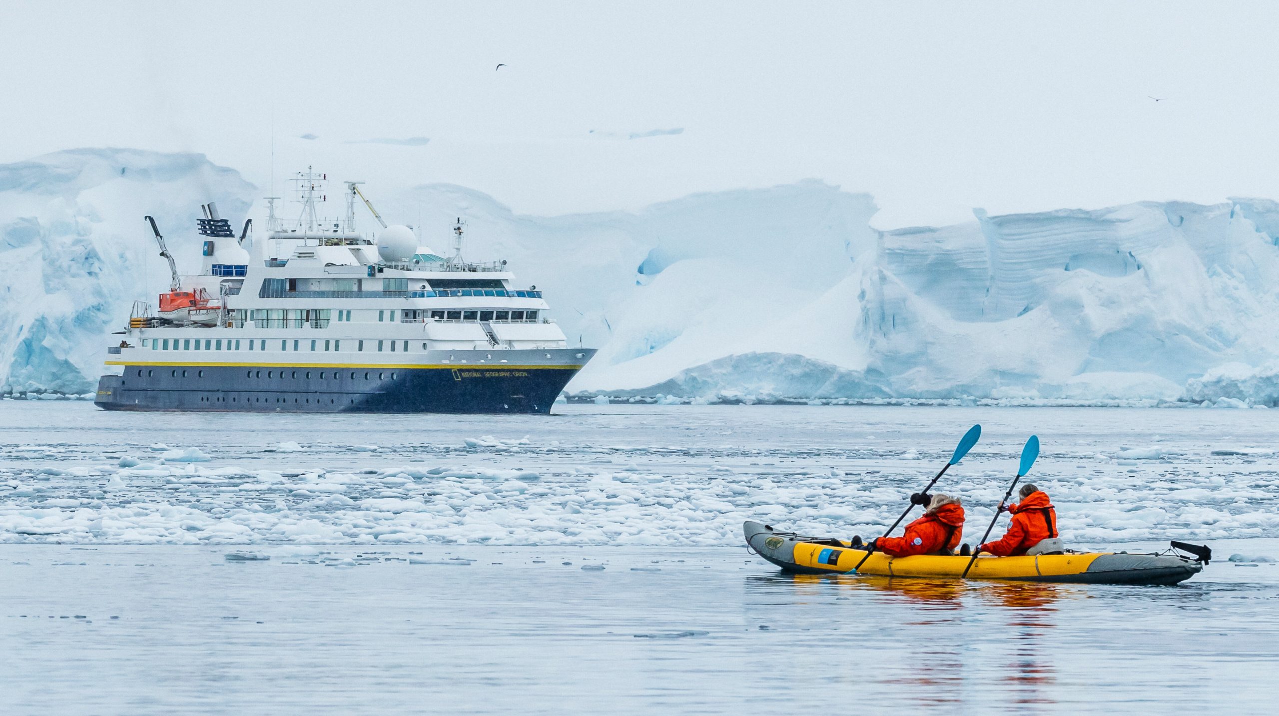 Kaykers paddling towards the ship National Geographic Orion.
