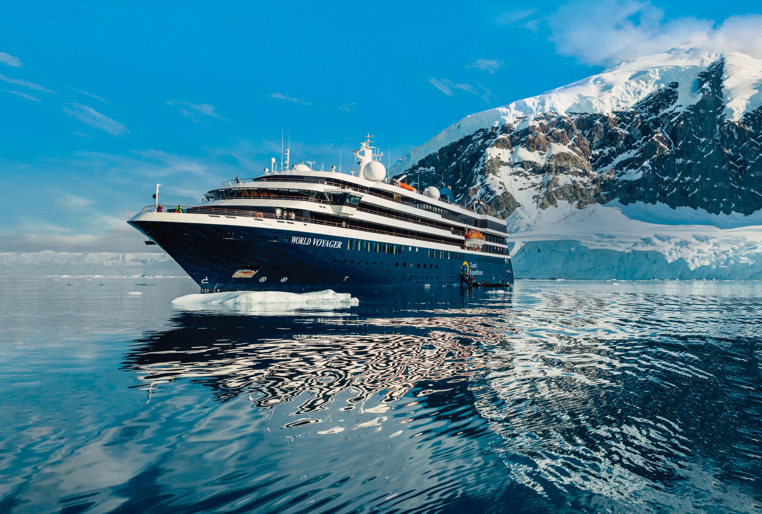 Exterior view of the ship World Voyager in Antarctica with glacier in background